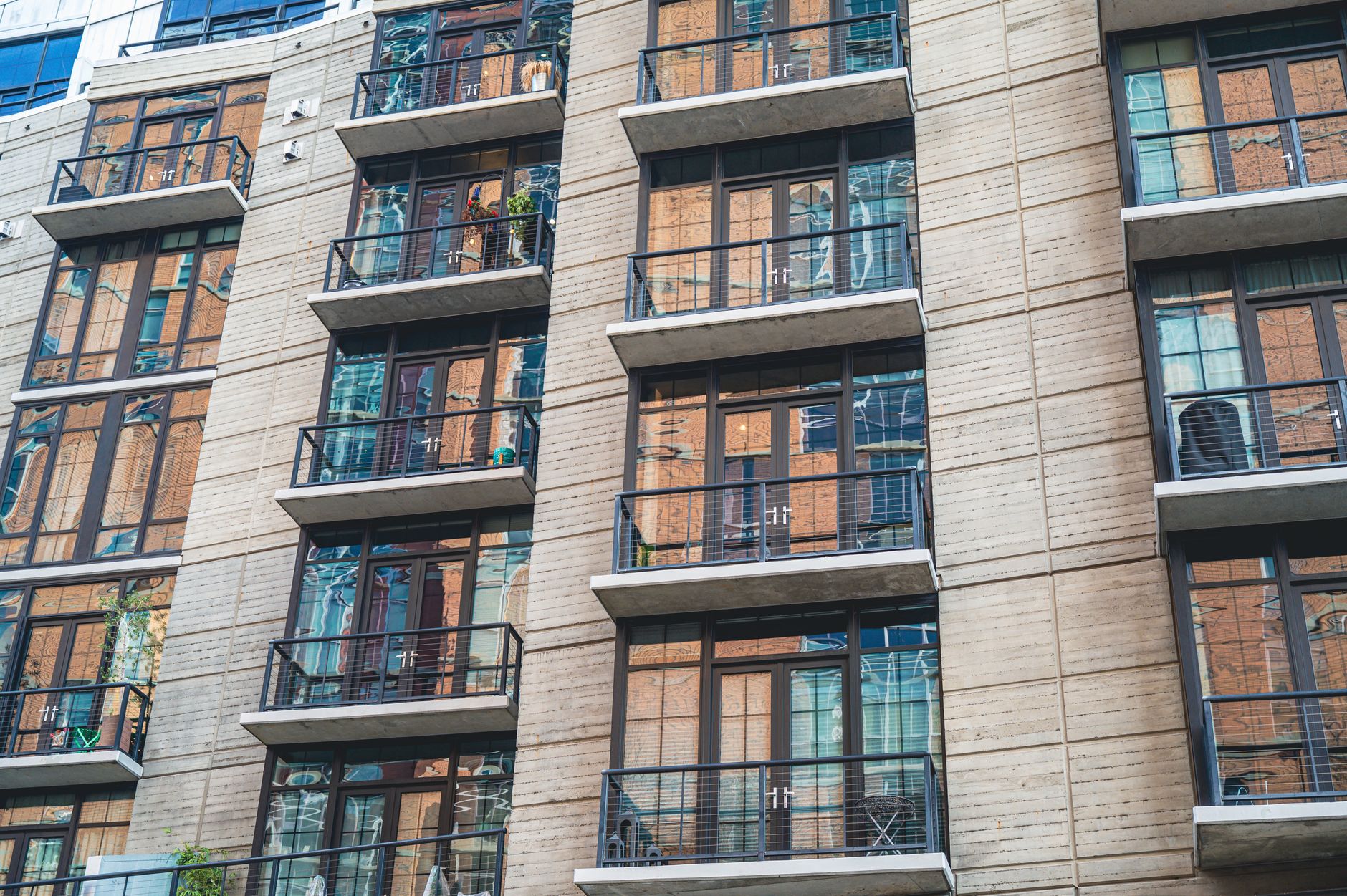 Modern apartment building with glass-balcony balconies